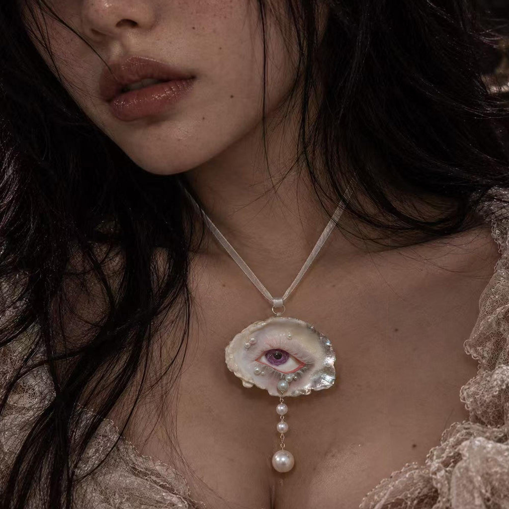 Nyra Lavender Gaze oyster-eye pendant worn on a fine chain.