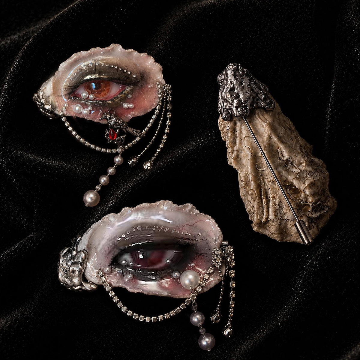 Display of Lilith Veil oyster eye pieces and brooch structure on black velvet